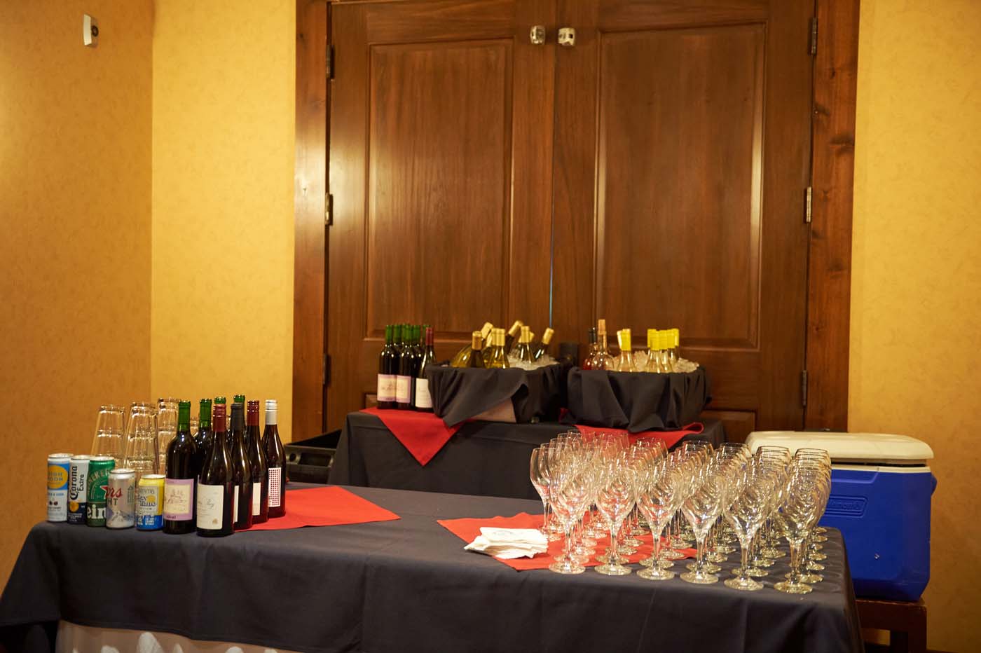 a refreshments table with wine glasses and drink options