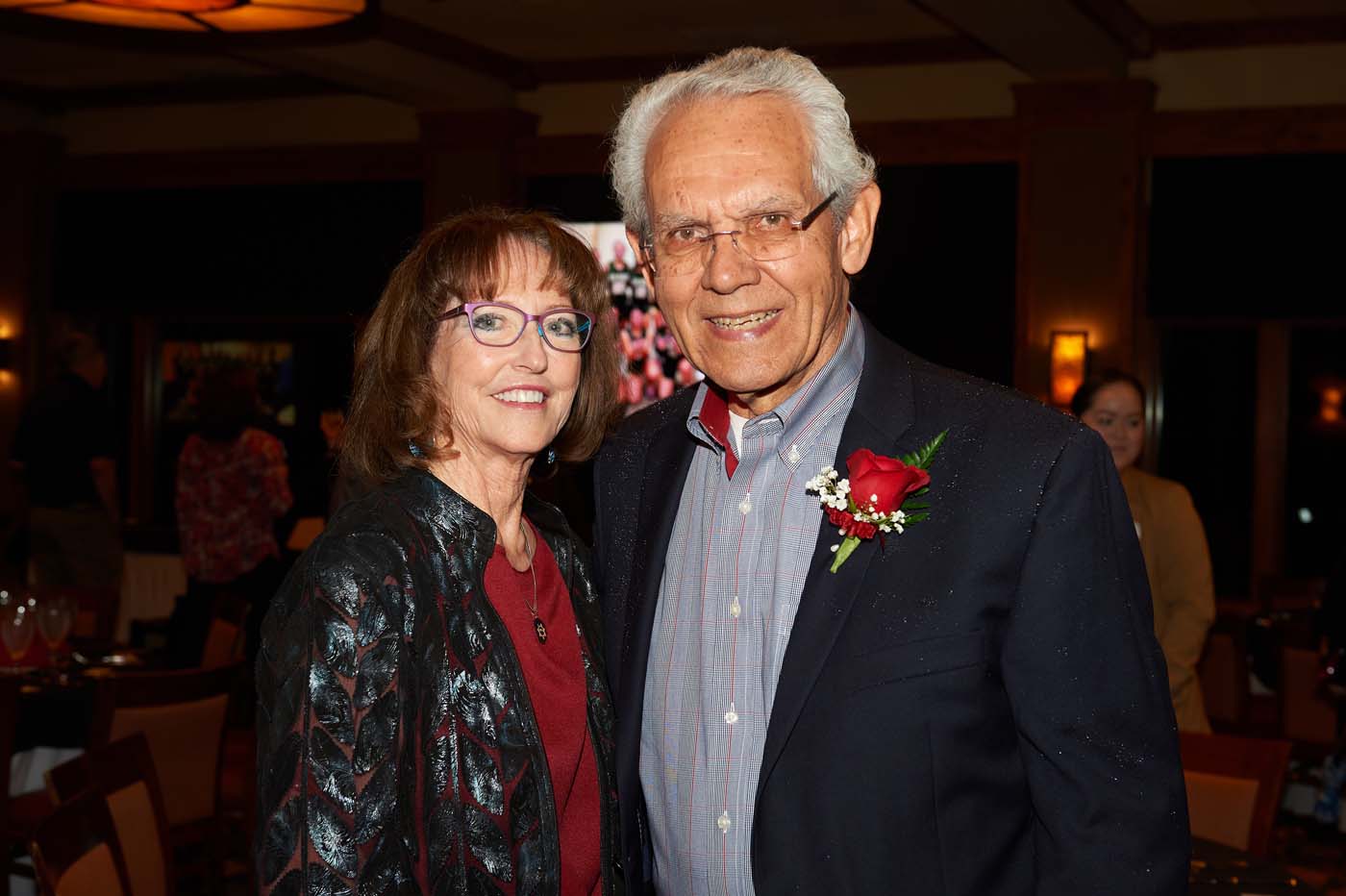 a man and a woman standing together and smiling