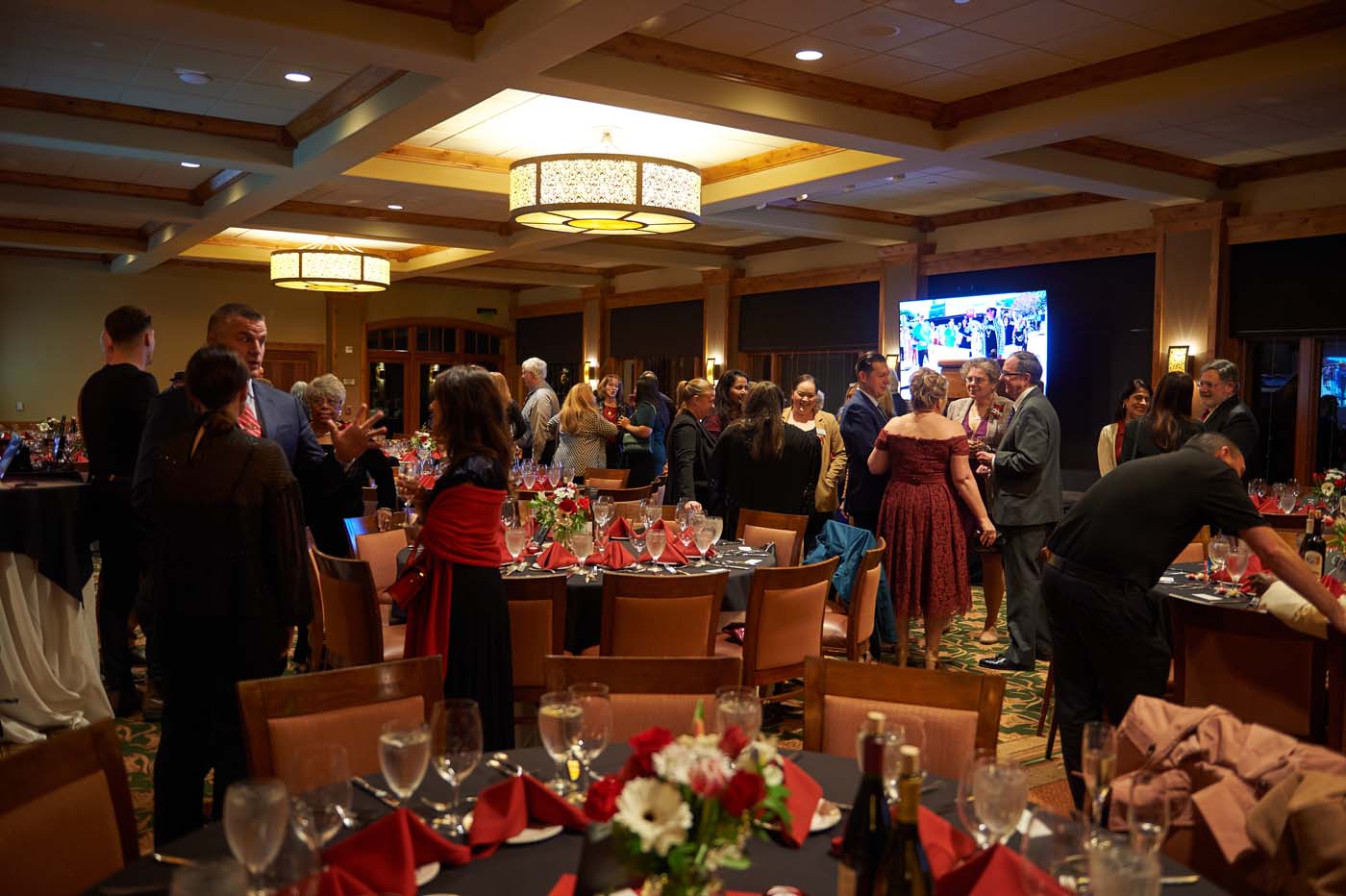 an event room filled with tables and people gathered around