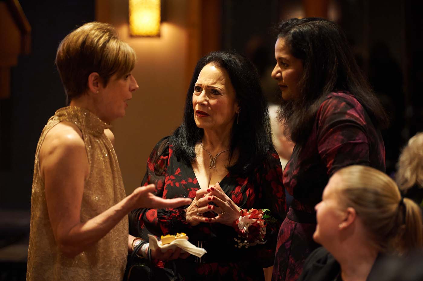 a group of women standing and talking