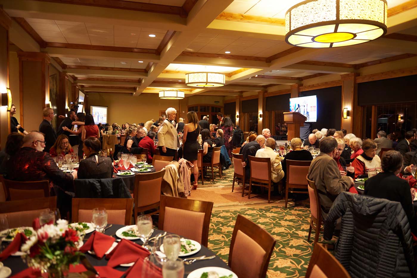 an event room filled with tables and people seated