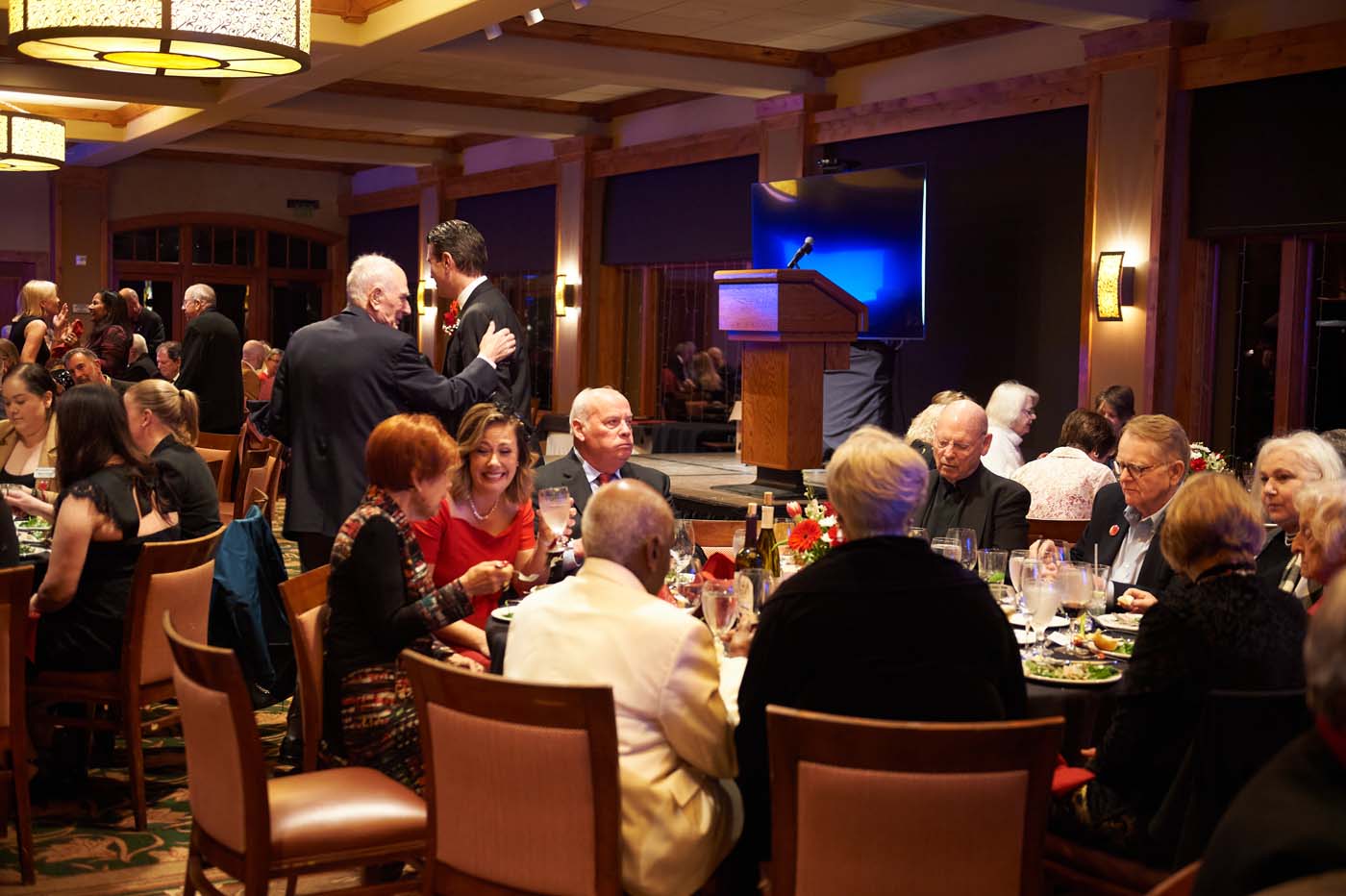 an event room filled with tables and people seated