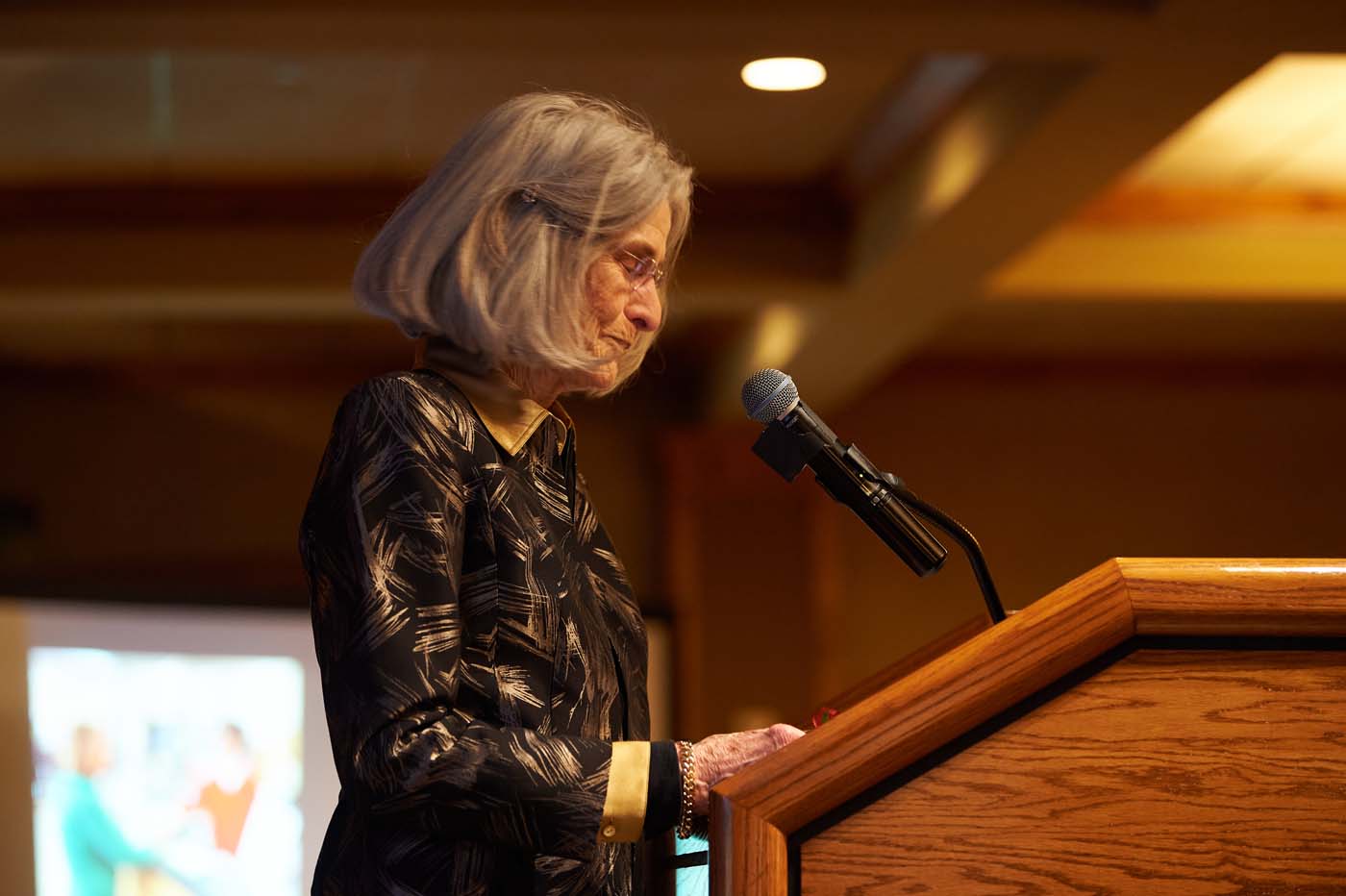 a woman at a podium with a microphone