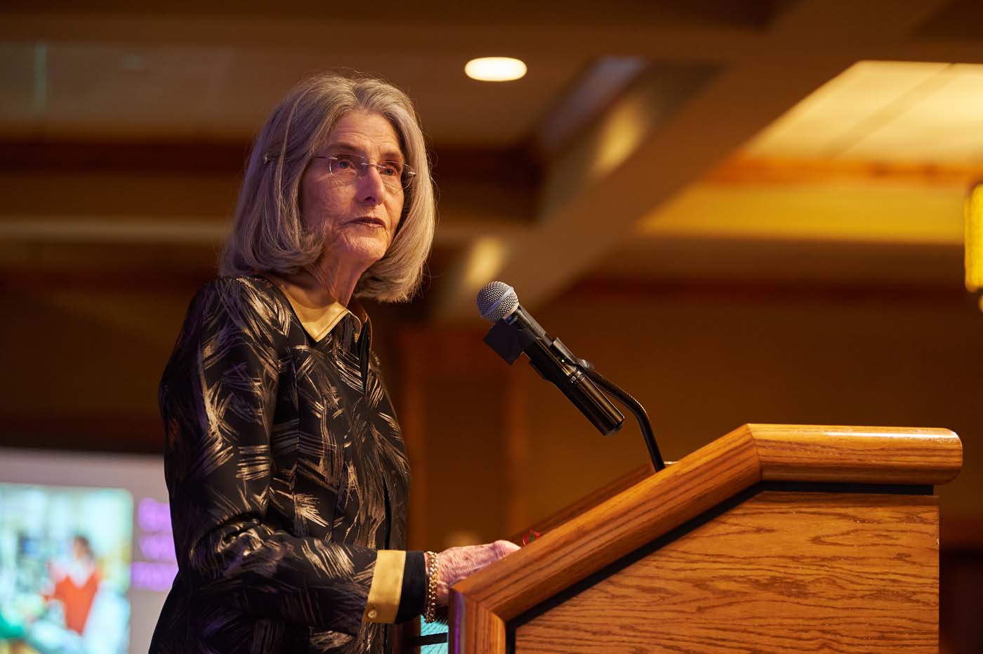 a woman at a podium with a microphone