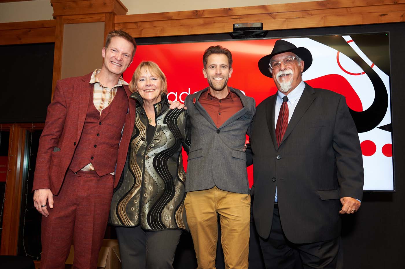 four people standing posing together
