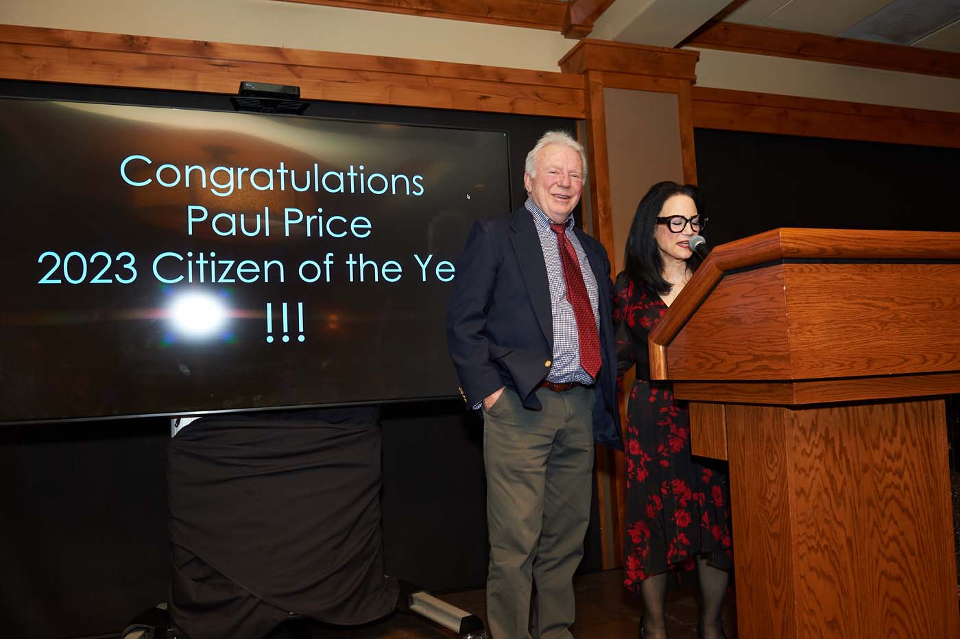 two people on a stage announcing rewards